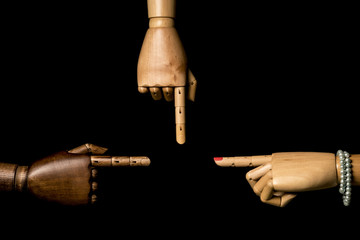 A hand of woman and man hands pointing something. On black background. With copy space.