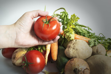 Hands holding freshly harvested tomatoes
