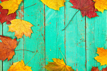 Naklejka na ściany i meble Autumn. Yellow leaves on the wooden texture. Cool. Season.