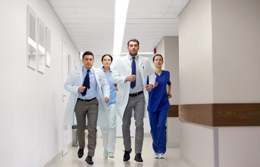 Fototapeta premium group of medics walking along hospital