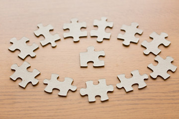 close up of puzzle pieces on wooden surface