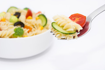 Pasta salad on a fork isolated on white background

