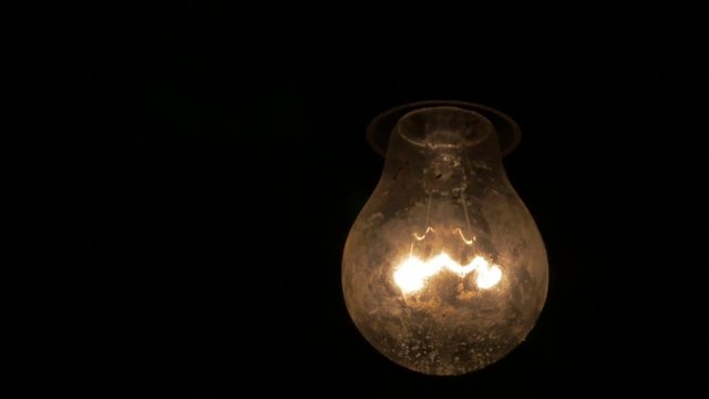 Dusty light bulb in the dark 1920X1080 HD video - Light bulb swinging horror scene 1080p FullHD footage 