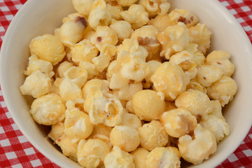 Close up of caramel coated popcorn in white bowl