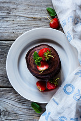 Chocolate pancakes with strawberries