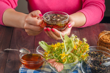Closeup of female holding a mug. Selective focus on hands and fi