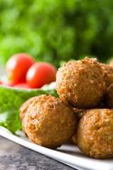 Vegetarian falafels and vegetables on a rustic wood

