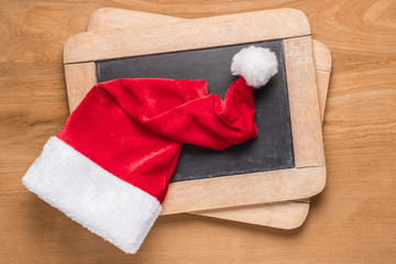 Obraz na płótnie Canvas Santa Claus hat on small blackboards