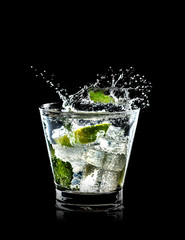 Mojito cocktail on black background with splash