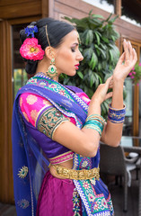 Fototapeta na wymiar Beautiful young indian woman in traditional clothing