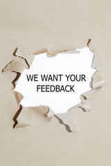The text WE WANT YOUR FEEDBACK behind torn paper