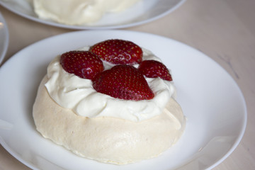  Pavlova cakes with meringue, whipped cream and fresh strawberri