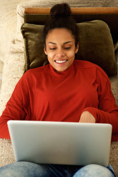 Beautiful woman using laptop on couch