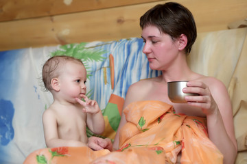 Obraz na płótnie Canvas Mother with son after sauna visit