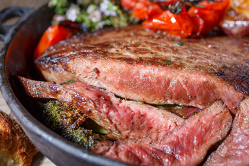a piece of medium rare beef with pieces cut and close-up.