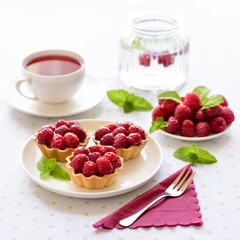 Fruit raspberries tarts or cupcakes on a table 