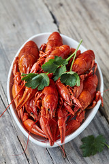 Red boiled crayfish in a white bowl