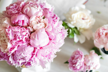 Bouquet of peonies in kraft paper bag
