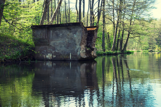 Old ruined postwar bridge over the river