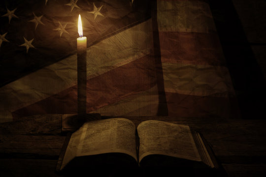 Old USA flag near candle. Open book and burning candle. Faith is a guiding light. We will find solace.