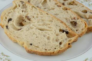 Close up of three slices of Kalamata olive bread on white plate