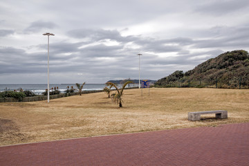 Paved Walkway Dry Winter Grass Verge Ocean and Skyline