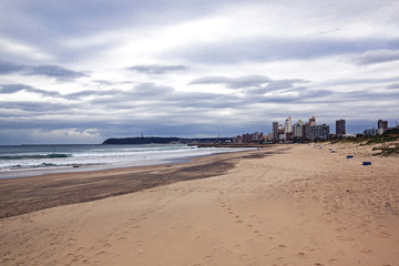 Empty Beach Shoreline City Skyline And  Overcast Cloudy Sky