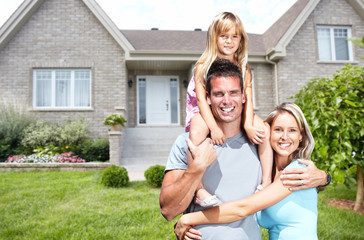 Happy family near new house.