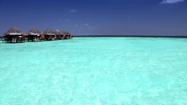 houses over transparent quiet sea water- tropical paradise, Maldives