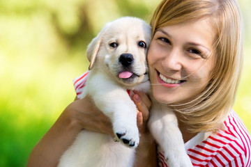 Girl with labrador puppy