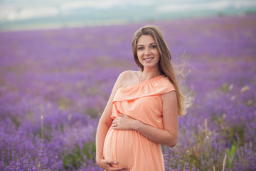 Lavender field and a happy pregnant woman