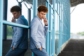 Handsome redhaired businessman talking on phone