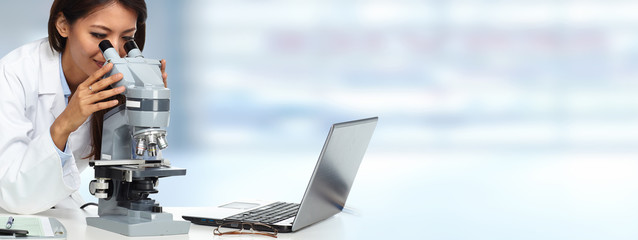 Chinese scientist woman with microscope.