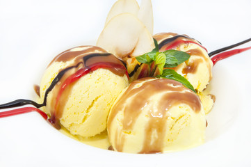 balls of ice cream decorated with mint on a white background in the restaurant