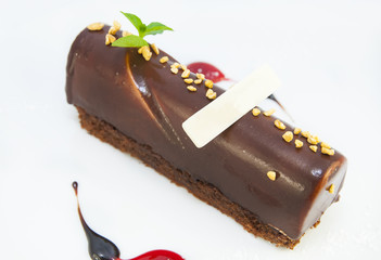 piece of chocolate cream cake on a white background in the restaurant