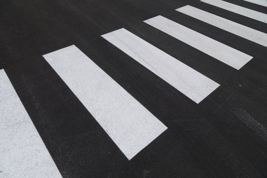 White Color Freshly Painted Pedestrian Crossing Sign On New Black Asphalt Ground.