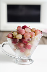 Frozen berries of gooseberries in a glass cup
