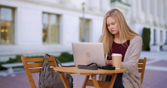 Intelligent school girl studying on laptop computer