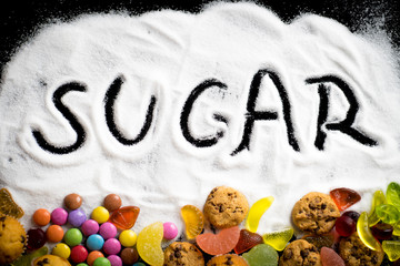 A mix of sweets, cookies, muffins, and candy with sugar spread