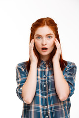 Portrait of young beautiful ginger girl over white background.