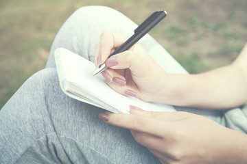 woman hand notebook on nature