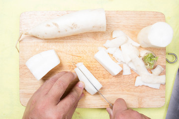 chef cutting parsnip before cooking