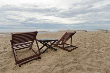 Cloudy sky on the beach and sea with relaxing table and chair