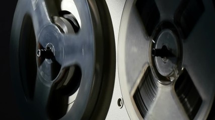 reel tape recorder, close-up, contrast lighting
