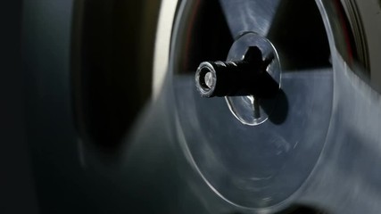 reel tape recorder, close-up, contrast lighting