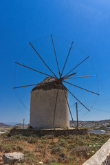 Fototapeta na wymiar White windmill in Town of Ano Mera, island of Mykonos, Cyclades, Greece