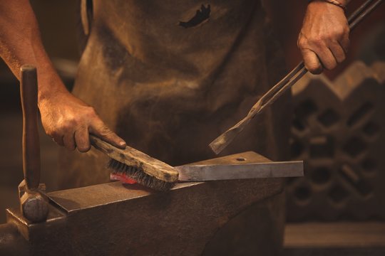 Blacksmith working on a heated iron rod