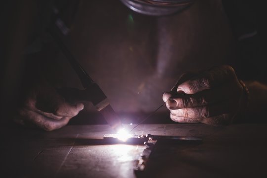 Blacksmith welding a metal