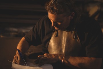 Blacksmith preparing notes