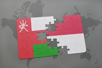 puzzle with the national flag of oman and indonesia on a world map background.